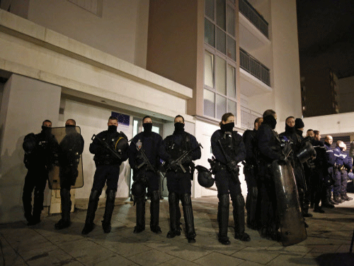 Police officers secure access to a residential building during investigations in the eastern French city of Reims, after the shooting against the Paris offices of Charlie Hebdo, a satirical newspaper. A police officer was wounded in a shootout in southern Paris on Thursday, a police source told Reuters, adding that it was unclear at this stage whether there was any link to the killings at the Charlie Hebdo magazine. Reuters photo