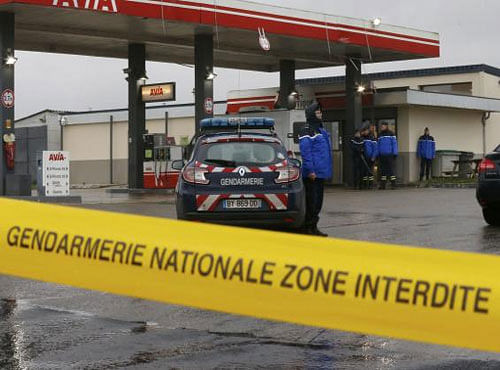 A Gendarmerie cordon is seen at a gas station in Villers-Cotterets, north-east of Paris, where armed suspects from the attack on French satirical weekly newspaper Charlie Hebdo were spotted in a car, January 8, 2015. Reuters