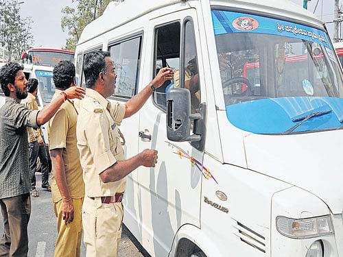 RTO Officials inspect vehicles near Silk Board junction in the City on Thursday. DH photo