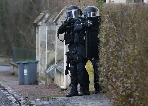 Members of the French GIPN intervention police forces secure a neighbourhood in Longpont, northeast of Paris as the Islamist militants who killed 12 people could strike again as a manhunt for two men widened across the country. Photo: Reuters