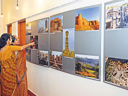 Visitors look at the photos of Unesco World Heritage Sites in India and abroad, on display at the Alliance Francaise de Bangalore on Friday. DH Photo