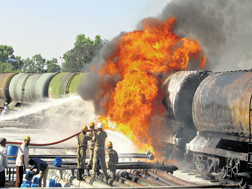 Inferno: Fire fighters try to put out the blaze that broke out at the BPCL depot wagon  besides Desur Railway Station in Belagavi taluk on Saturday. dh photo