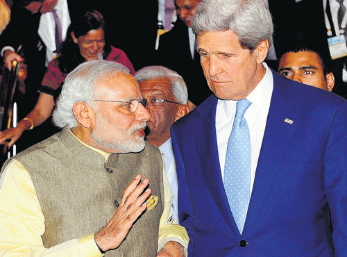 Prime Minister Narendra Modi discusses a point with US Secretary of State John Kerry in Gandhinagar on Sunday. REUTERS