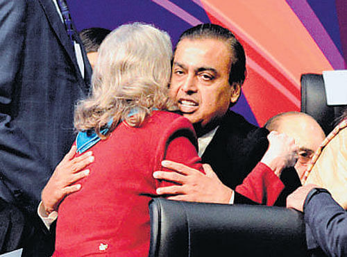 Industrialist Mukesh Ambani (C) receives a hug froma dignitary. AFP