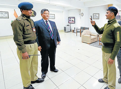 Security officers click pictures with Hari Shankar Brahma, after he assumed office as the newchief election commissioner in NewDelhi on Friday. PTI