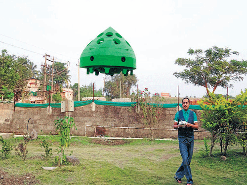 Up it goes Mahesh Mahajan with his remote-controlled car that can fly up to 150 feet high.   DH Photo