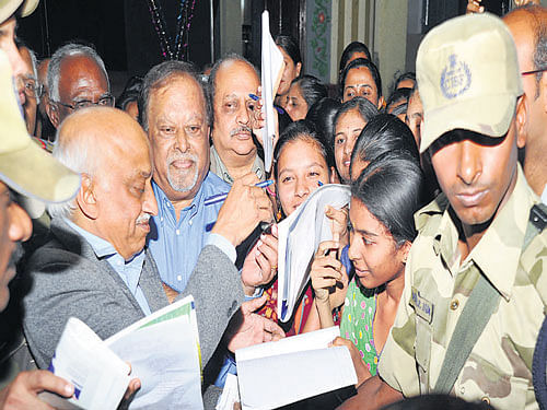 one for me, please New Isro chairman Dr A S Kiran Kumar signs autographs for students during a visit to his alma mater  National College, Basavanagudi, on Monday. DH PHOTO