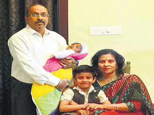 satisfied Pranjit and Snigdha with kids Abheek and Meyyan.