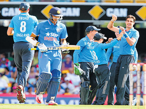five-star show: England's Steven Finn (right) celebrates with his team-mates the dismissal of India's Axar Patel. AP Photo.