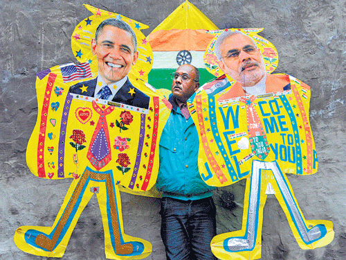 A kite-maker poses with kites depicting US President Barack Obama and Prime Minister Narendra Modi in Amritsar on Wednesday.  AFP