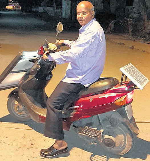 Balagurunathan on his solar-powered vehicle in Madurai.