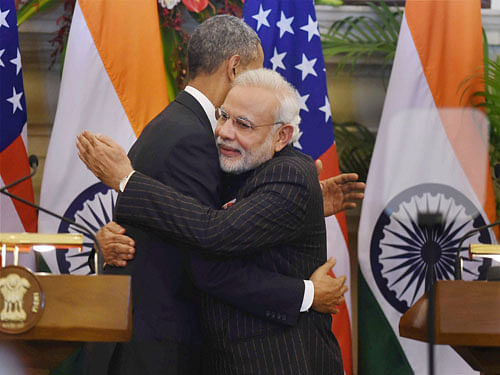 Prime Minister Narendra Modi and US President Barack Obama hug each other after a joint press conference at Hyderabad House in New Delhi on Sunday. PTI Photo