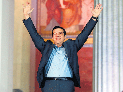 Leader of Syriza left-wing party, 40-year-old Alexis Tsipras waves to his supporters outside Athens University Headquarters, on Sunday, after winning the snap general election. AP Photo