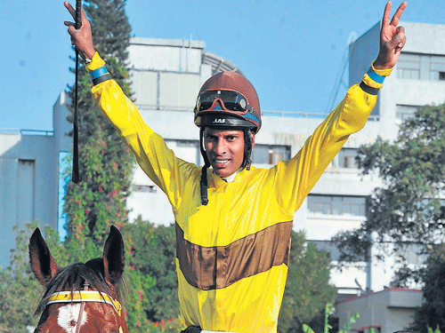 triumphant: Jockey A Sandesh celebrates after piloting Bold Majesty to victory in the Legacy Bangalore Derby-2015 at the Bangalore Turf Club in Bengaluru on Monday. Trainer S&#8200;Ganapathy leads in the winner. dh photos/ Srikanta Sharma R