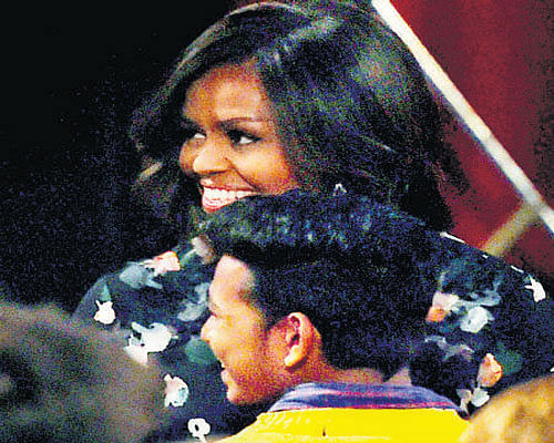 First Lady Michelle Obama interacts with Vishal.  PTI