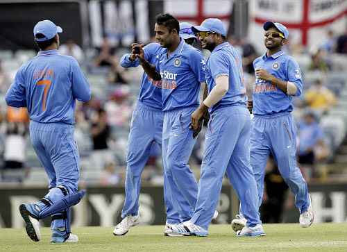 India's Stuart Binny celebrates with teammates after taking the wicket of England's Eoin Morgan during their One Day International (ODI) tri-series cricket match at the WACA ground in Perth. Reuters photo