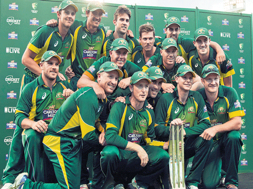 Champion performance: A jubilant Australian team with the tri-series trophy after defeating England in the final at Perth on Sunday. reuters photo