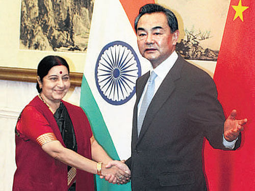 External Affairs Minister Sushma Swaraj with her  Chinese counterpart Wang  Yi in Beijing on Sunday. PTI