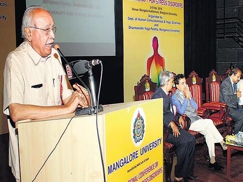 Mangalore University former vice chancellor and former UGC member Prof M I Savadatti speaks after inaugurating a three-day international conference on 'Yoga therapy for stress disorders' at Mangalagangothri on Tuesday. DH photo