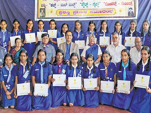 Scouts and Guides receive award certificates at a function held at DC's Bungalow at Balmatta in&#8200;Mangaluru on Sunday. Scoutsdistrict Commissioner N G Mohan, Guides District Commissioner Irene D'Cunha look on among others. DH Photo