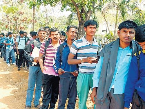 Youth line up for the registration at the Army recruitment rally held at Mahathma Gandhi grounds in Udupi on Tuesday. DH photo