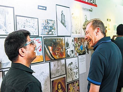 'V for Vendetta' co-creator David Lloyd interacts with a young artist at the 'Legend of the Drawing Board' meet in the City.