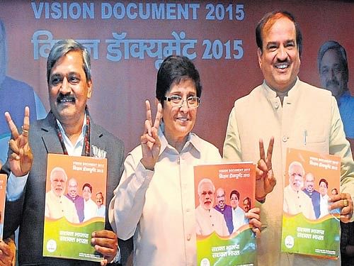 BJP CM candidate Kiran Bedi along with Delhi BJP president Satish Upadhyay, at the release of party's Vision Documents for Delhi Assembly Election, in New Delhi on Tuesday. Parivartan Sharma/ DH photo