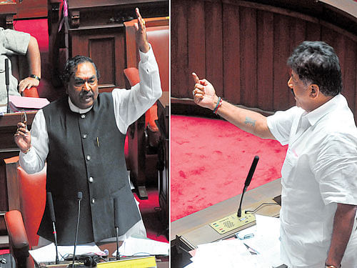 POINT, COUNTER POINT: Opposition leader K S Eshwarappa (left) engages in a heated debate as minister D K Shivakumar seeks to voice his opinion in the Legislative Council session on Tuesday. DH Photo