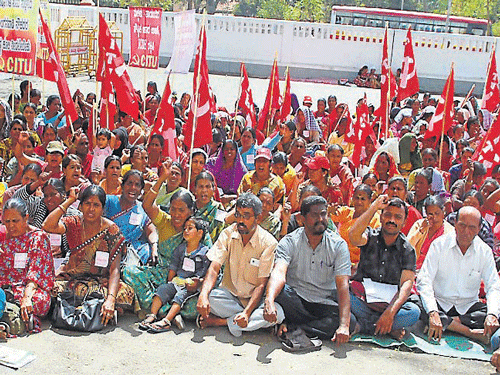 Anganwadi workers continued their stir for the third day, in front of Deputy Commissioner's office, in Hassan, on Wednesday. DH photo