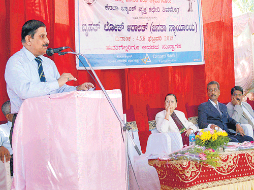 Canara Bank Deputy General Manager H Shivaram speaks at Rashtriya Lok Adalat organised in association with Legal Services Authority in Chikkamagaluru on Wednesday. Principal District and Sessions Judge H S Kamala and others look on. DH photo