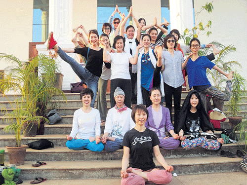 A group comprising 18 South Korean delegates, including Wonkwang Digital University, South Korea, Pro Chancellor Prof Seo Jeong Soon, display yogic postures during an international conference on 'Yoga  therapy for stress disorders' organised by the Department of Human Consciousness and Yogic Sciences and Dharmanidhi Yoga Peetha of Mangalore University in Mangalagangothri in Mangaluru. DH photo