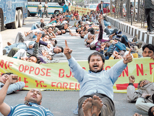Activists stage a demonstration in Guwahati on Wednesday against BJP's vision document. PTI