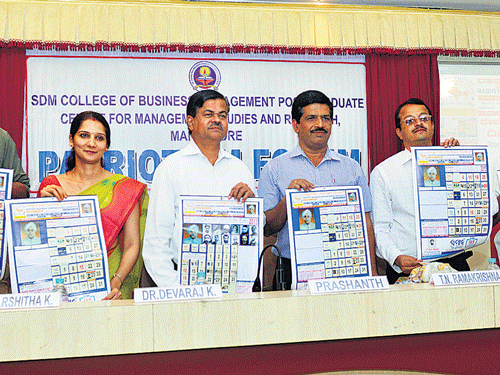 Rashtra Gaurava Samrakshana Parishat President T N Ramakrishna releasing the calendar.  SDM College of Management Director Prof K Devaraj among others look on.DH&#8200;photo