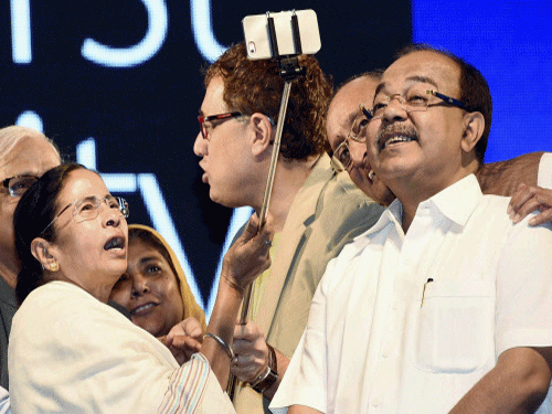 West Bengal Chief Minister Mamata Banerjee takes selfie with Finance Minister Amit Mitra, Mayor, Shovon Chaterjee  in Kolkata on Thursday. PTI