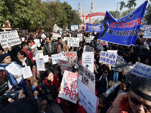Christians shout slogans protesting outside Sacred Heart Church against recent attacks on churches in New Delhi. PTI