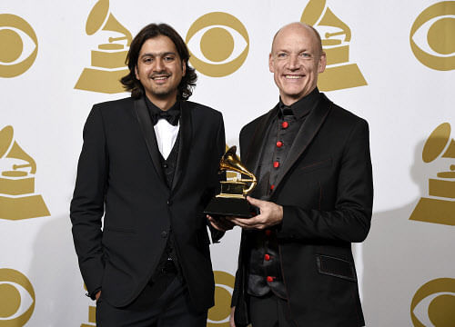 Ricky Kej, left, and Wouter Kellerman of Winds of Samsara pose in the press room with the award for best new age album at the 57th annual Grammy Awards at the Staples Center on Sunday, Feb. 8, 2015, in Los Angeles. AP photo