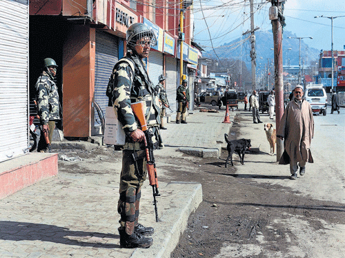 GUARDEDSTREETS: Security personnel stand guard during a strike call given by separatist groups on the second anniversary of execution of Parliament attack convict Mohammad Afzal Guru, at Lal Chowkin Srinagar on Monday. PTI