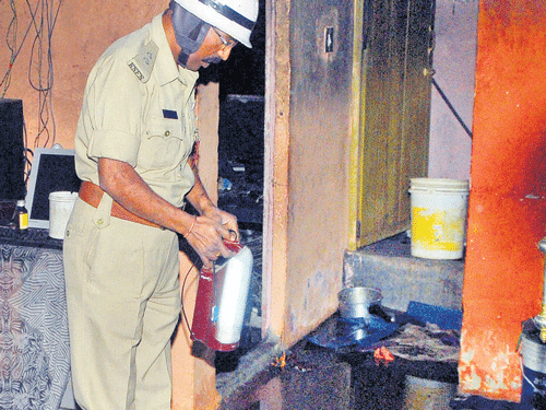 TRAGIC DEATH: Fire officials inspect the housewhere two children Naveen and Kanishka Rani (inset)were charred to death onMonday. DH PHOTO