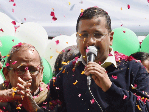 AAP convener Arvind Kejriwal introduces his father to the the party volunteers during a programme to celebrate the party's victory in the Delhi Assembly polls, at Patel Nagar in New Delhi on Tuesday. PTI Photo