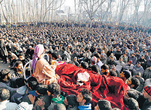 Villagers carry body of Farooq Ahmad Bhat, a civilian killed in security forces' firing, in Srinagar on Tuesday. REUTERS