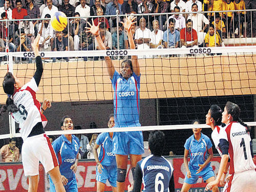 hard hit Chandigarh's Anju tries to smashes past  Karnataka's Smitha K S during their volleyball tie at the 35th National Games in Kozhikode on Wednesday. PTI