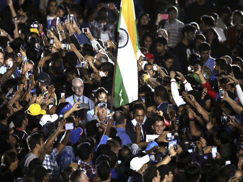 Mahendra Singh Dhoni makes his way through the crowd, to be presented on stage during the ICC Cricket World Cup 2015 opening event. Reuters