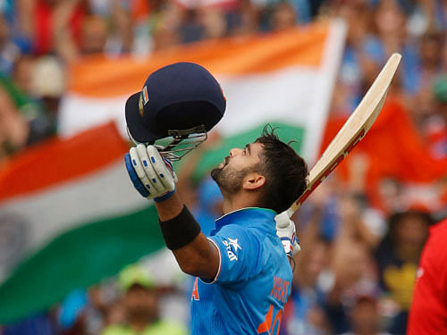 India's batsman Virat Kohli reacts after scoring a century during their Cricket World Cup match against Pakistan in Adelaide February 15, 2015. Reuters Photo.