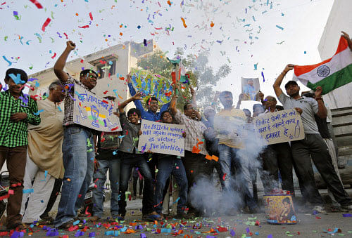 Fans celebrate after India beat Pakistan, in their first match of the 2015 World Cup Cricket tournament in Adelaide, in the western Indian city of Ahmedabad, February15, 2015. REUTERS
