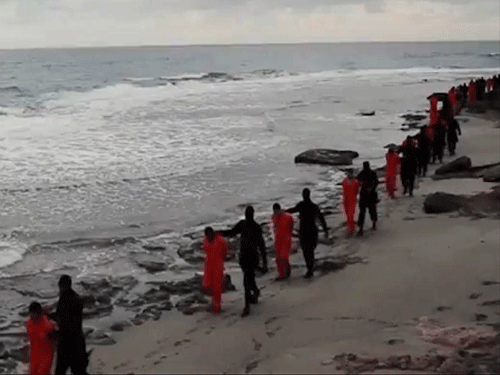 This image made from a video released Sunday Feb. 15, 2015 by militants in Libya claiming loyalty to the Islamic State group purportedly shows Egyptian Coptic Christians in orange jumpsuits being led along a beach, each accompanied by a masked militant. Later in the video, the men are made to kneel and one militant addresses the camera in English before the men are simultaneously beheaded. The Associated Press could not immediately independently verify the video. AP Photo