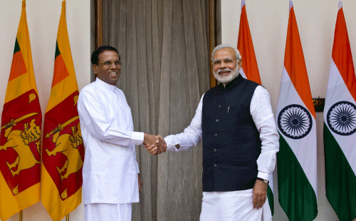 Sri Lanka's President Maithripala Sirisena, left, and Indian Prime Minister Narendra Modi shake hands as they pose for photos before their meeting in New Delhi, India, Monday, Feb. 16, 2015. Sri Lanka's new leader is underlining India's importance as a regional ally by making it his first official foreign destination as president, following years of uneasy relations with New Delhi and international pressure to speed up post-civil war reconciliation efforts at home. AP photo