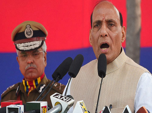 Union Home Minister Rajnath Singh addresses as Police Commissioner B S Bassi looks on during the Delhi Police Raising Day Parade in New Delhi on Monday. PTI photo