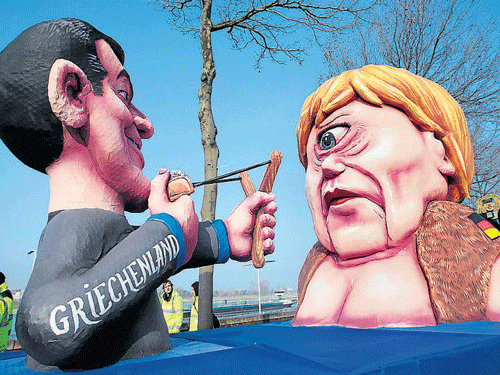 A carnival float with papier-mache caricatures of German Chancellor Angela Merkel (right) and a figure representing Greece. Photo: Reuters