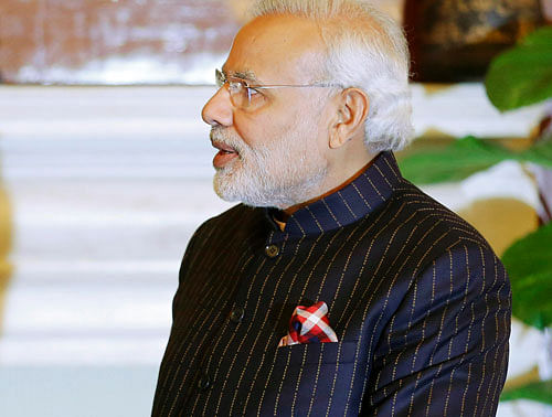 Prime Minister Narendra Modi's controversial pinstripe monogrammed bandhgala suit that he wore during US President Barack Obama's visit to India last month is up for auction starting here tomorrow.Reuters photo