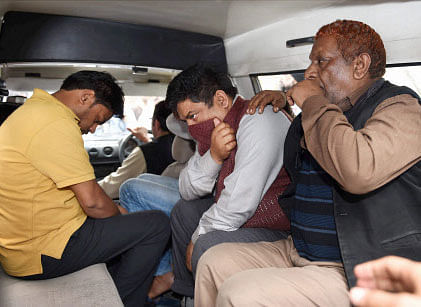 Police take away accused in Petroleum Ministry document leak, from Shastri Bhavan in New Delhi on Friday. PTI Photo